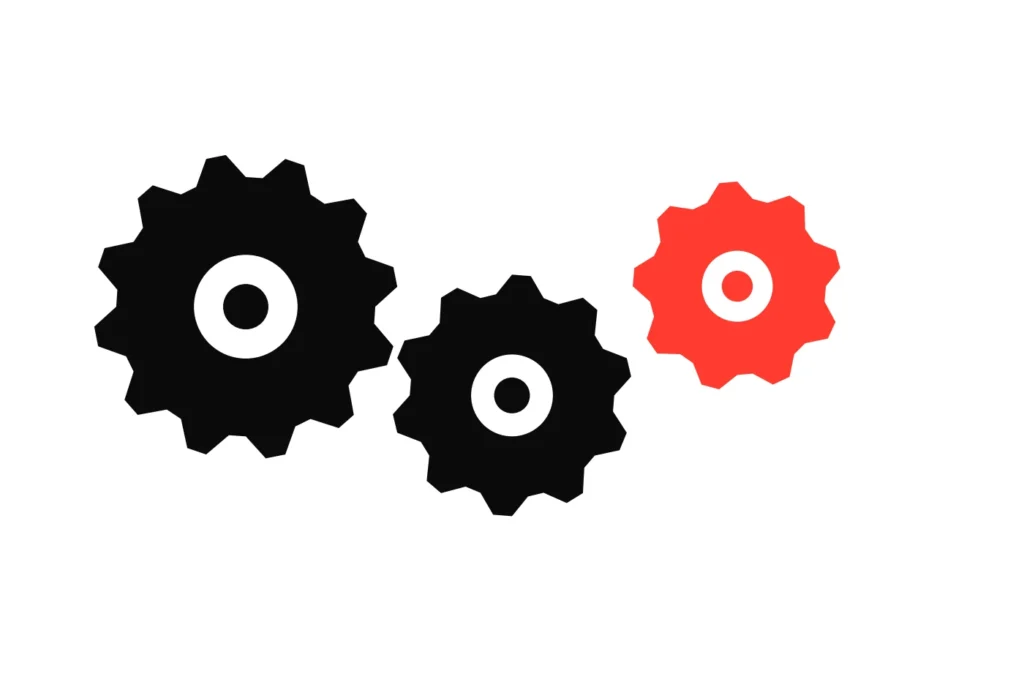 Three meshed gears, the last in red, decimal prices driving each other across the legs of a multiple