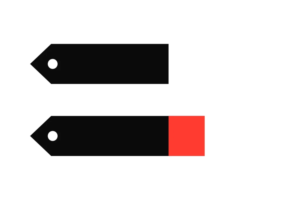 Two price tags, one plain and one longer with a red extension, the price charged against the fair price